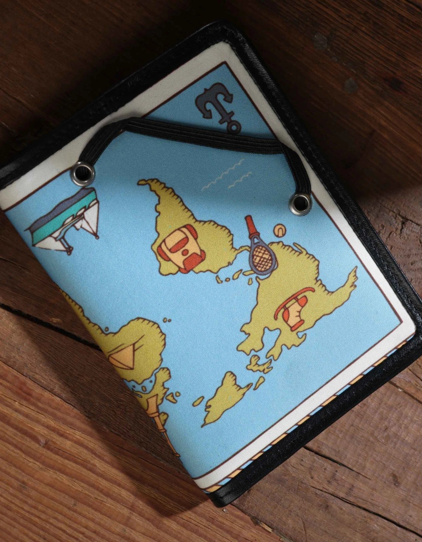 Cartoonish map design on a product packaging against a wooden surface