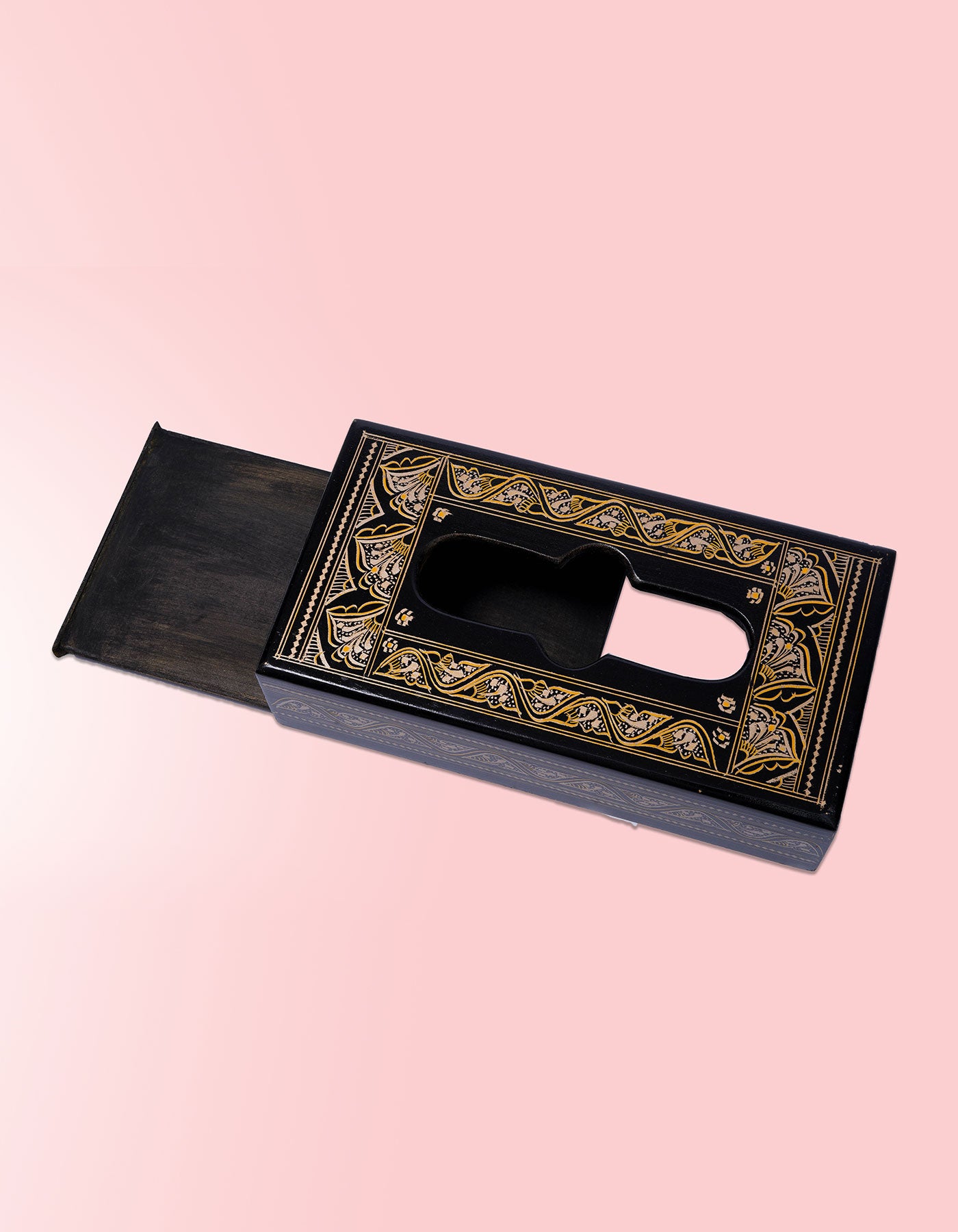 Decorative black and gold box on a pink background