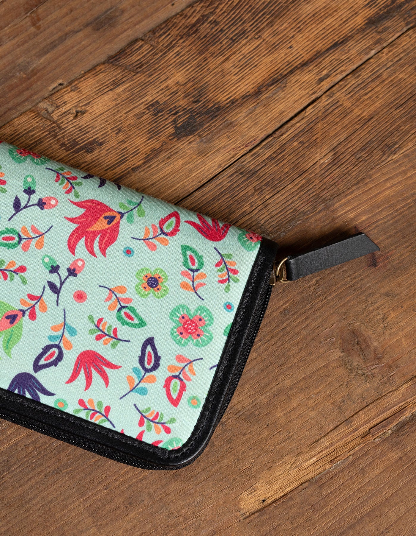 Floral-patterned pouch on a wooden surface