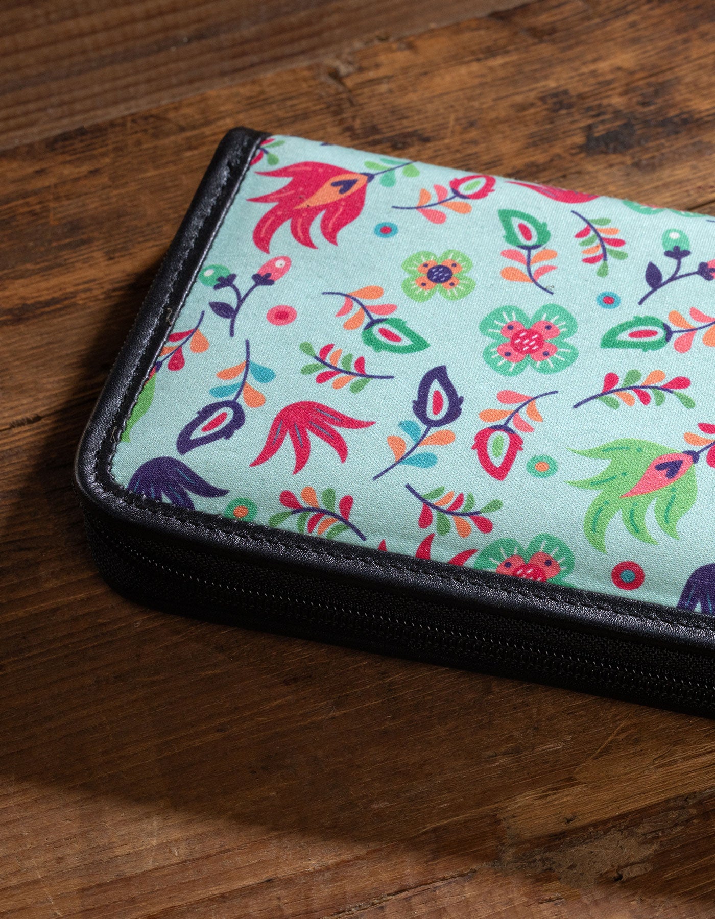 Floral-patterned pouch on a wooden surface