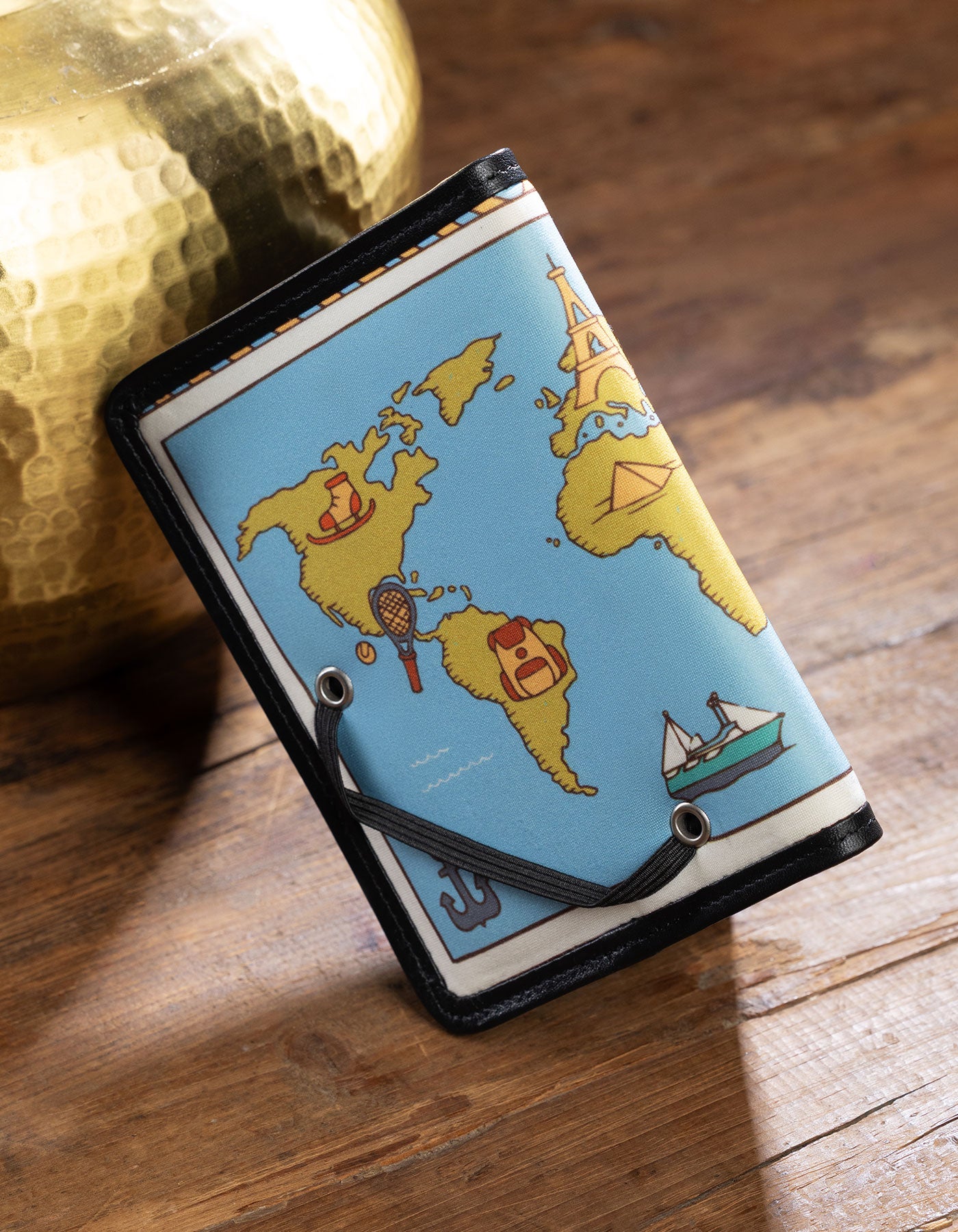 Wallet with world map design on a wooden surface