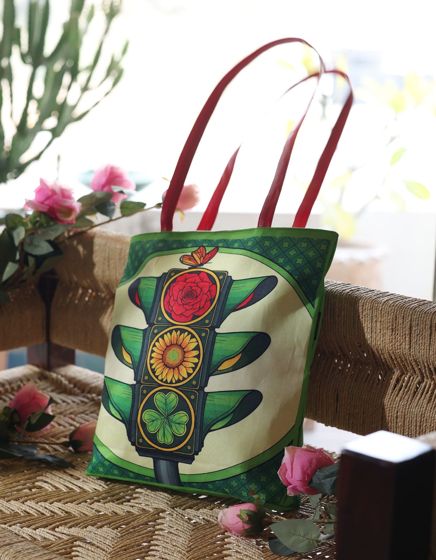 Colorful tote bag with traffic light design on a woven surface with flowers.