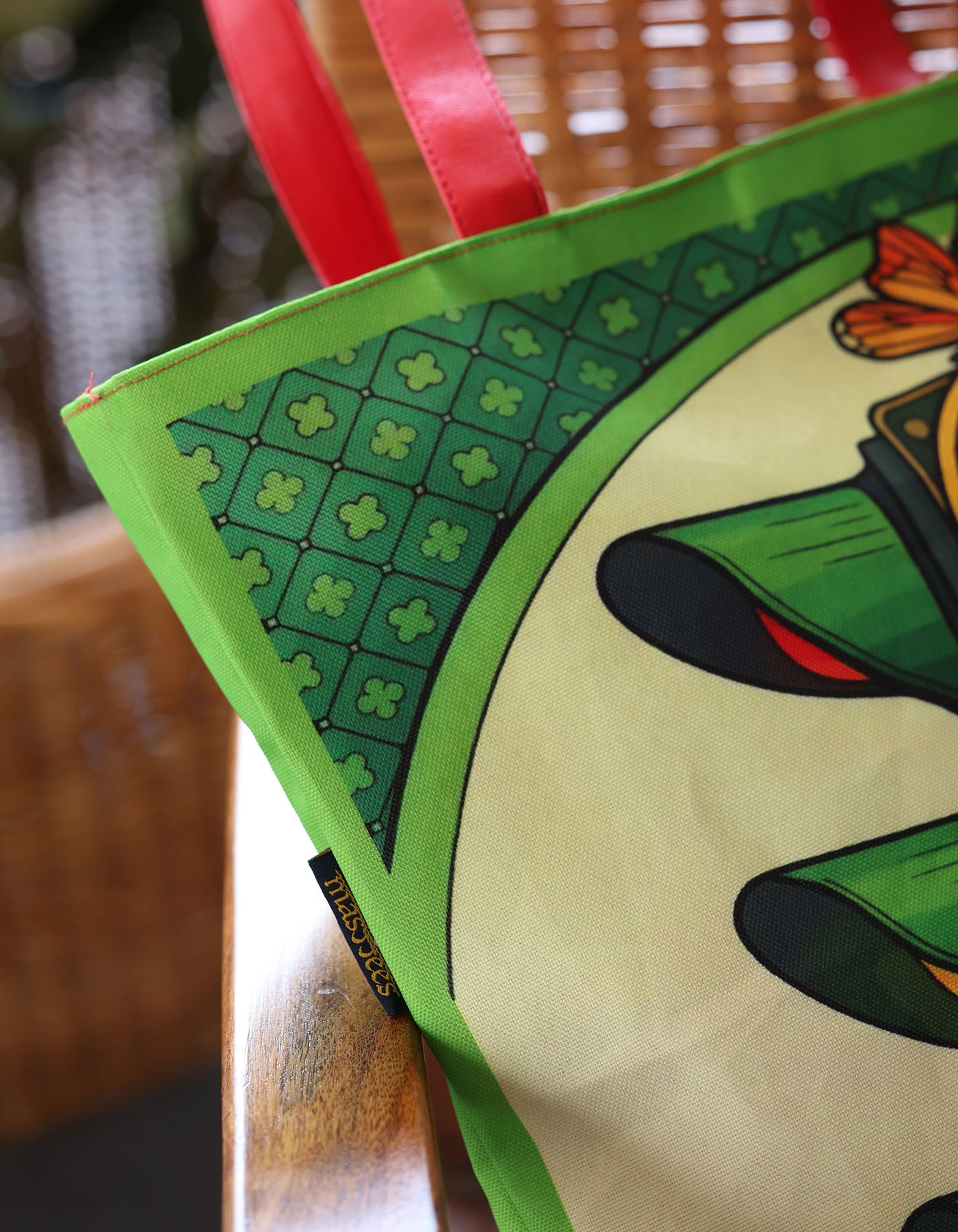 Green book with a butterfly illustration on a wooden surface