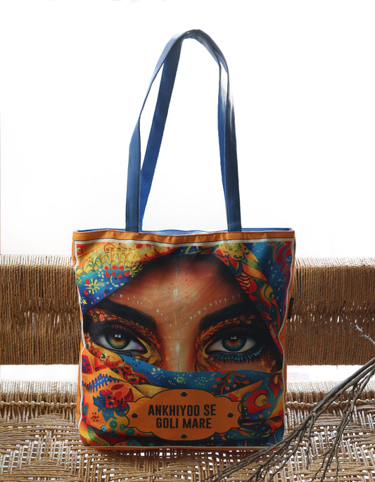 Tote bag with a colorful design of a face and text on a woven surface