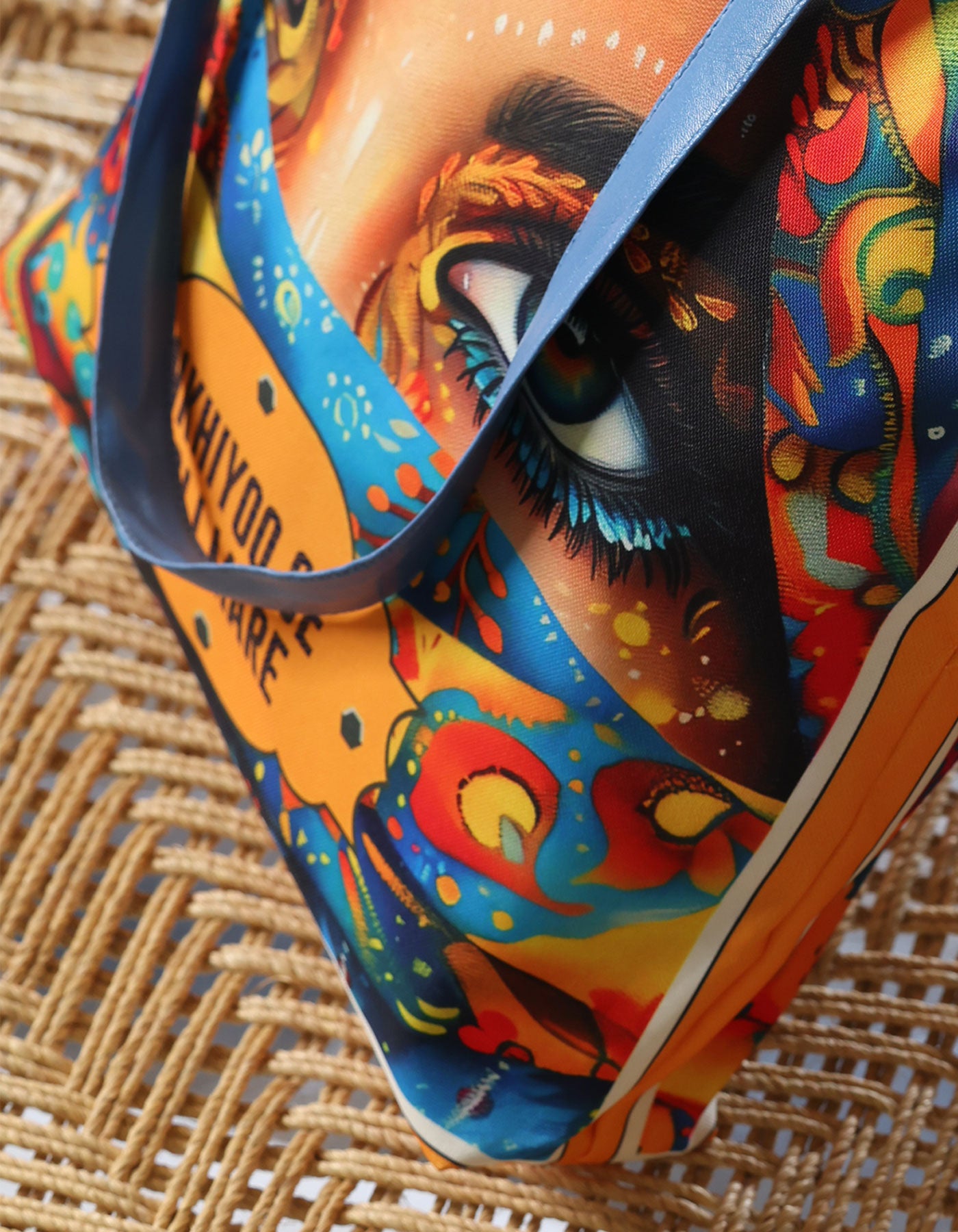 Colorful bag with artistic design on a woven surface