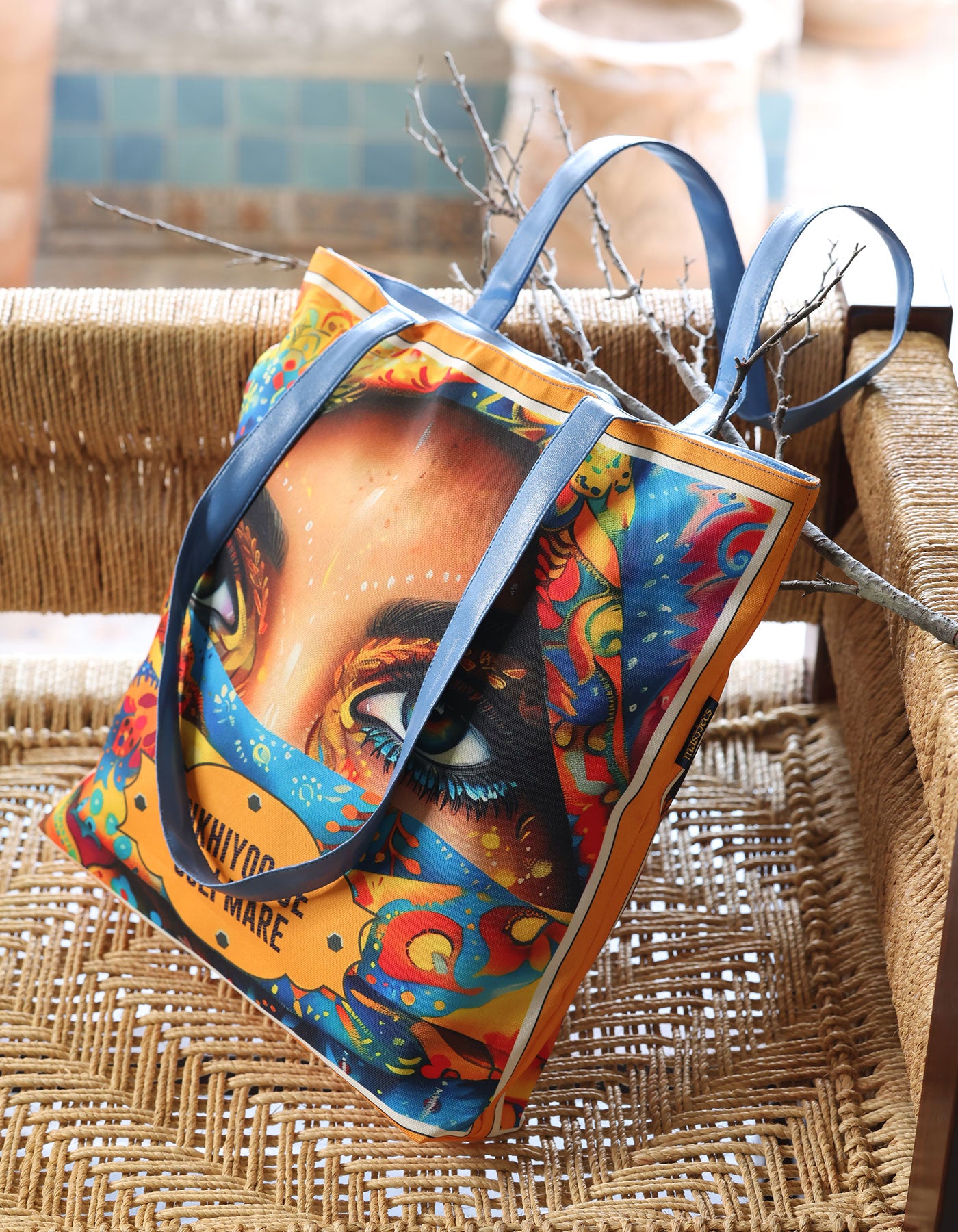 Colorful handbag with artistic design on a woven surface