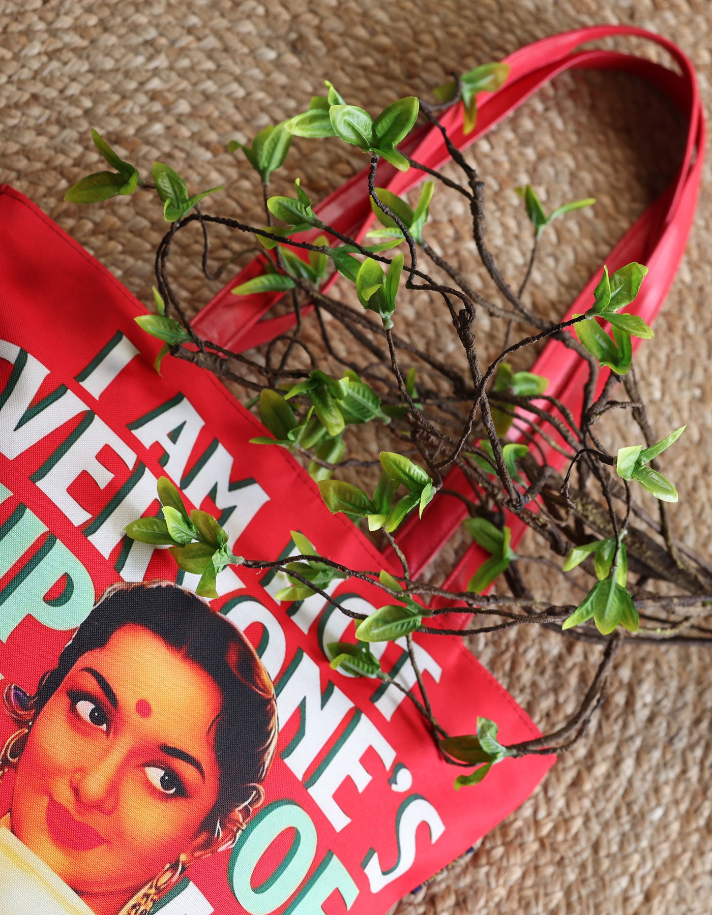 Red bag with a printed face design on a textured surface