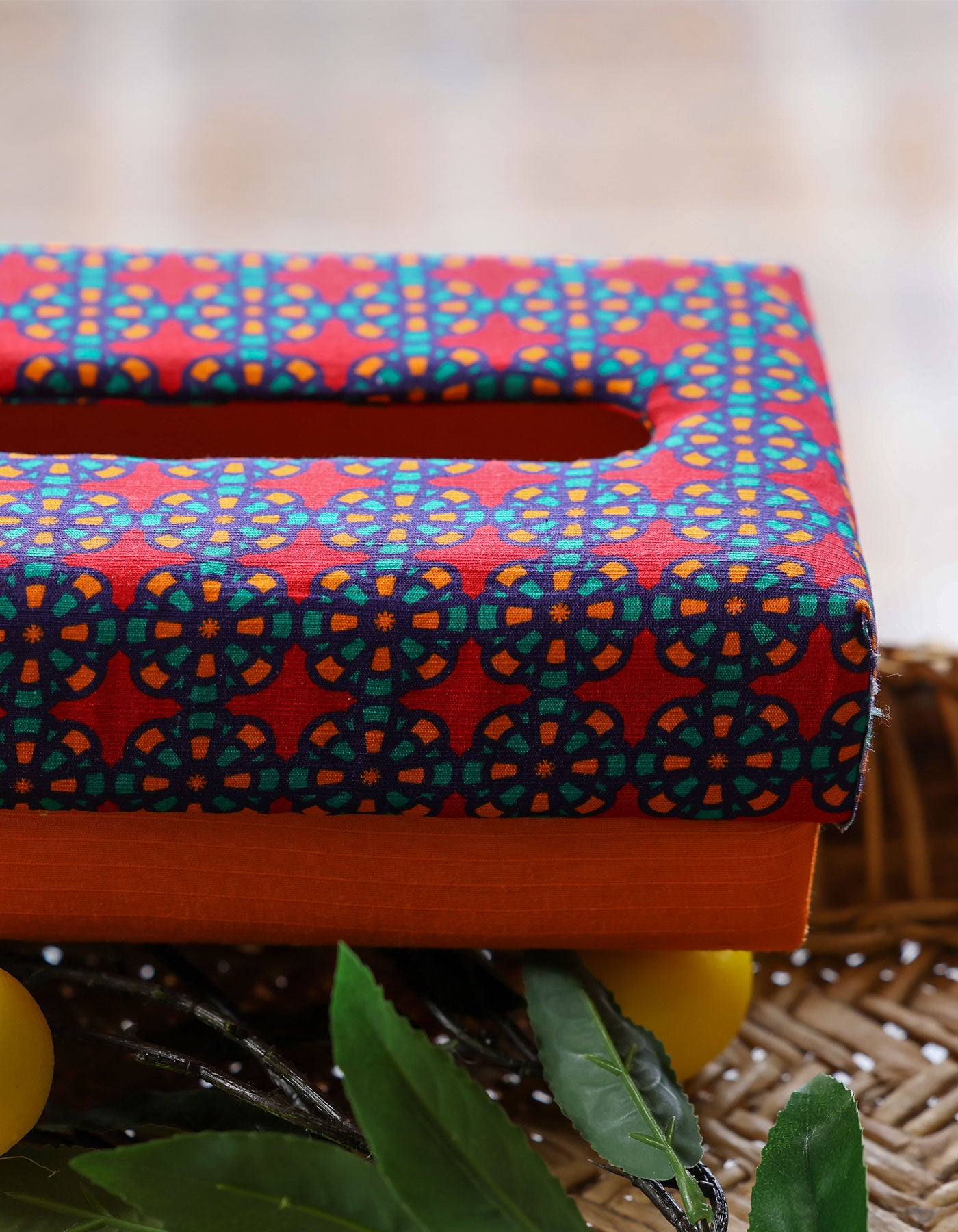 Colorful patterned tissue box cover on a blurred background