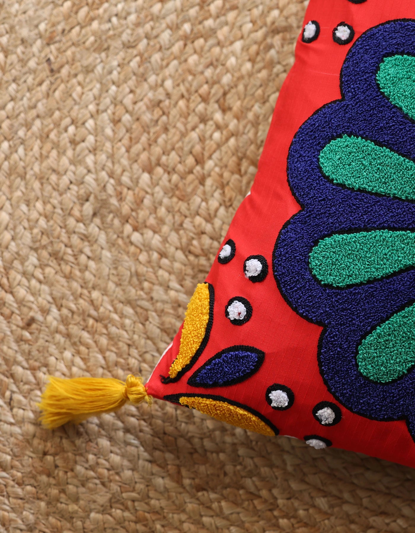 Decorative pillow with colorful embroidery on a textured surface