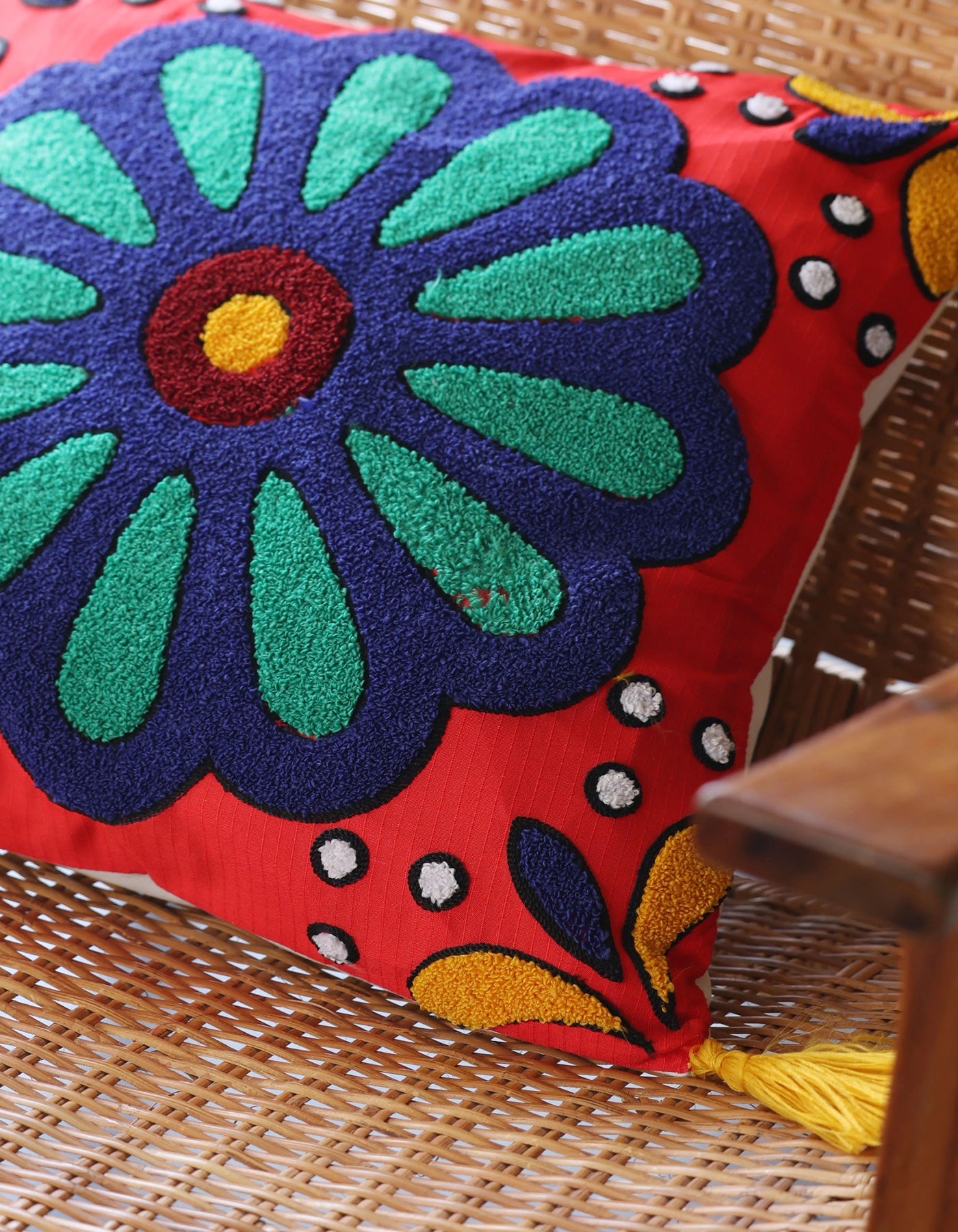 Decorative pillow with a colorful floral design on a woven surface