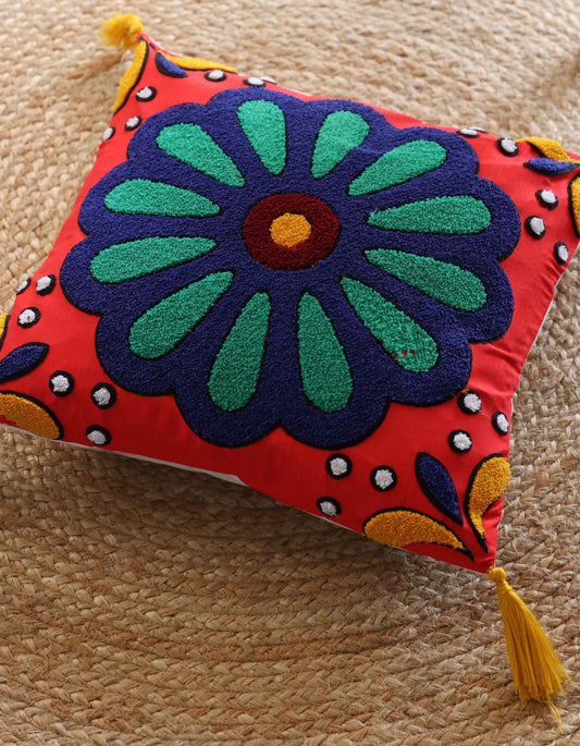 Colorful decorative pillow with floral design on a textured surface