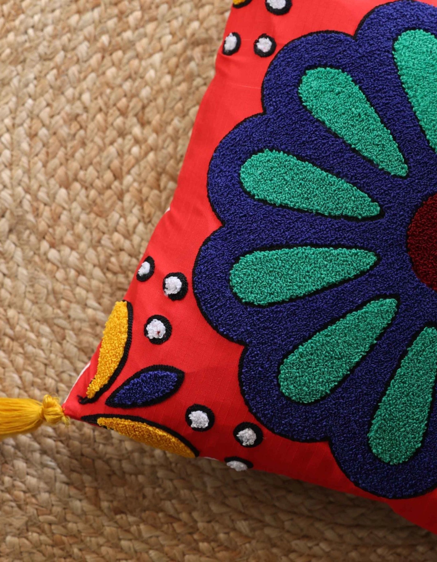 Decorative pillow with a colorful floral design on a textured surface