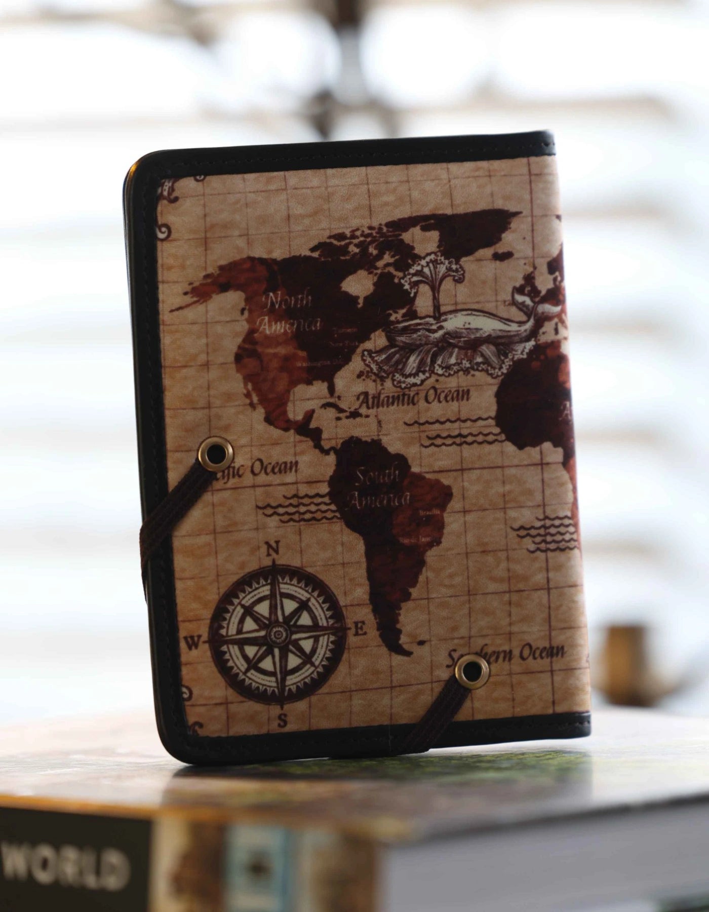 Notebook with world map design on a blurred background