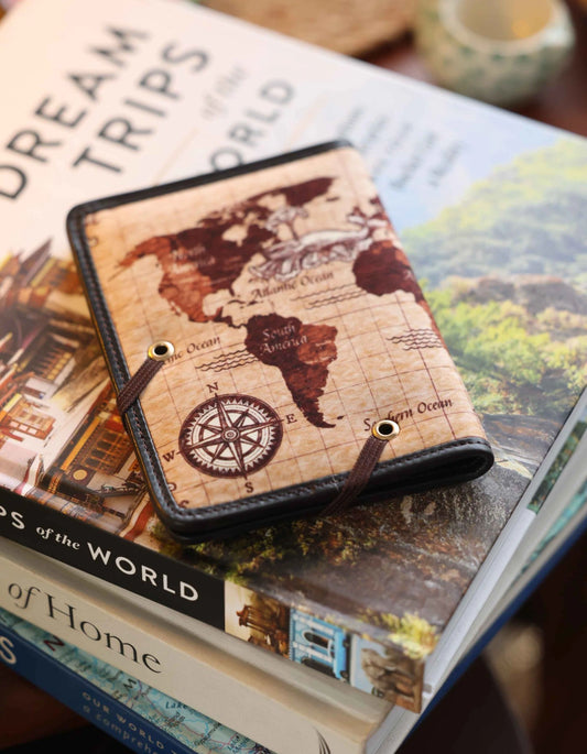 Phone case with world map design on top of a book