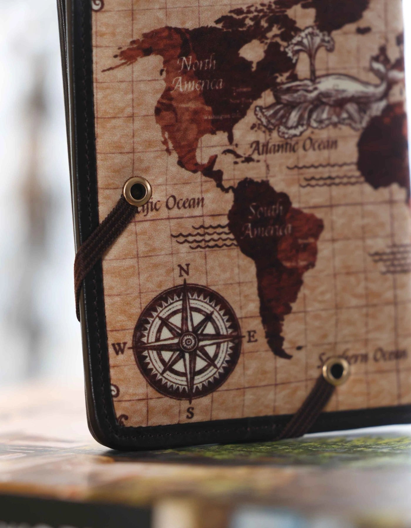 Phone case with world map design on a blurred map background