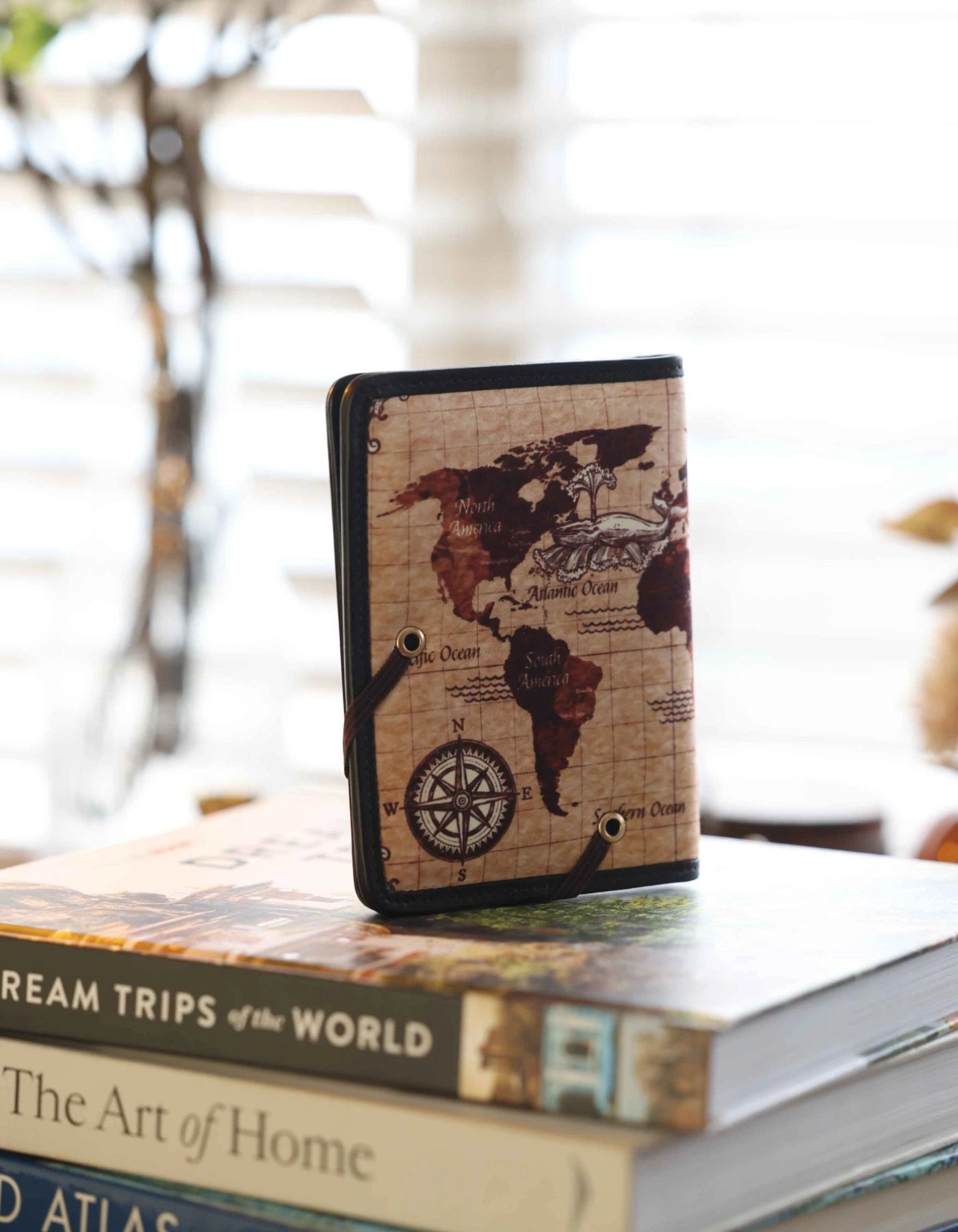 Phone case with world map design on top of books