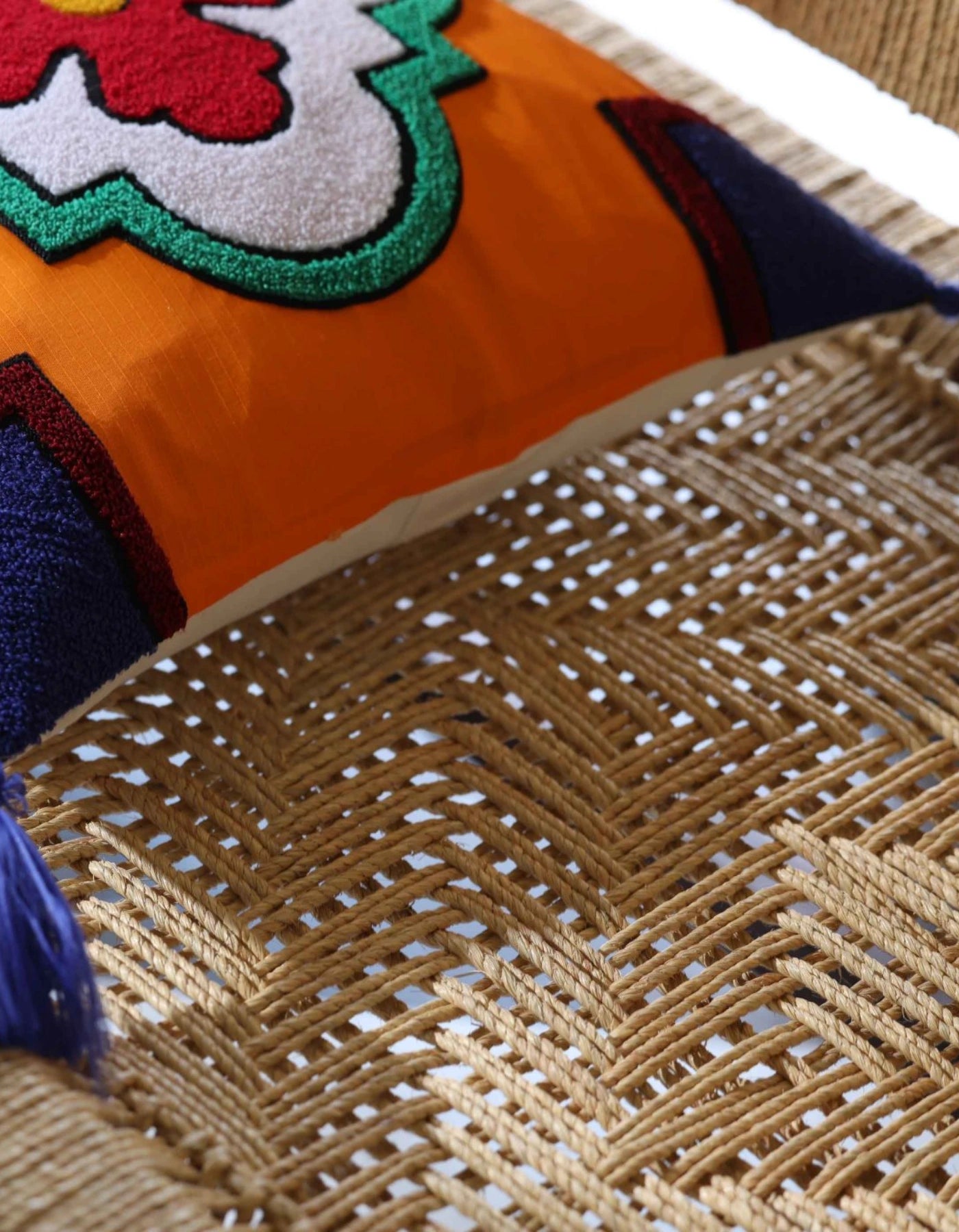 Close-up of a colorful fabric with floral patterns on a woven surface.