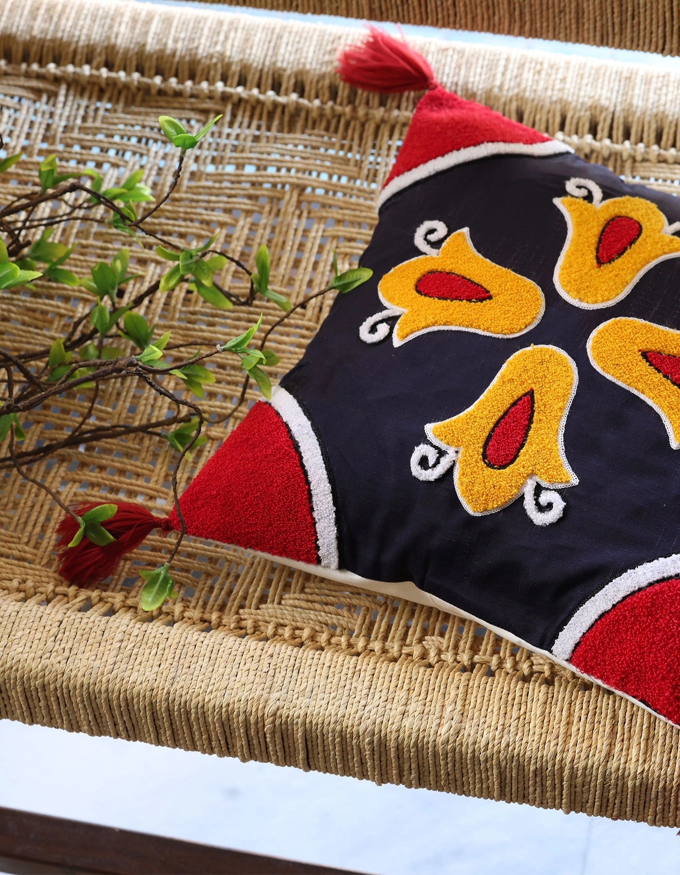 Decorative pillow with bird pattern on a woven surface