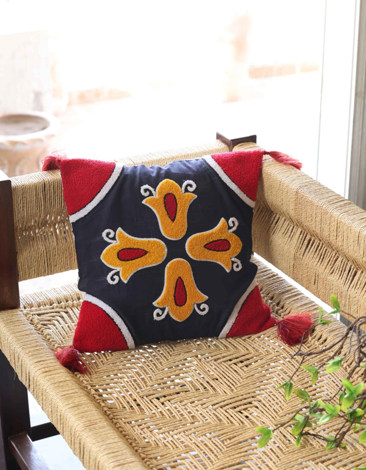 Decorative pillow with geometric pattern on a woven chair