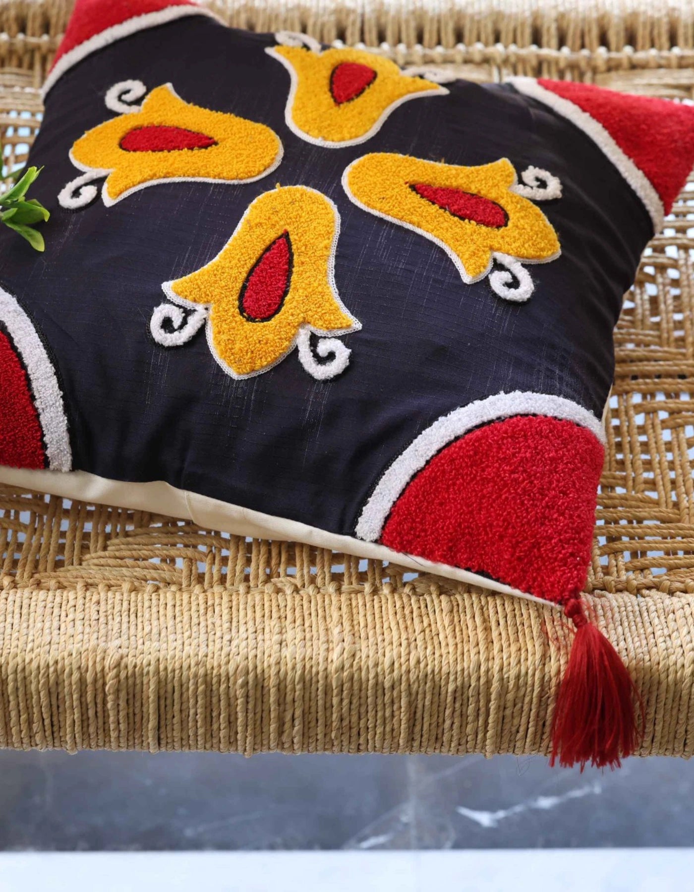 Decorative pillow with colorful patterns on a woven surface