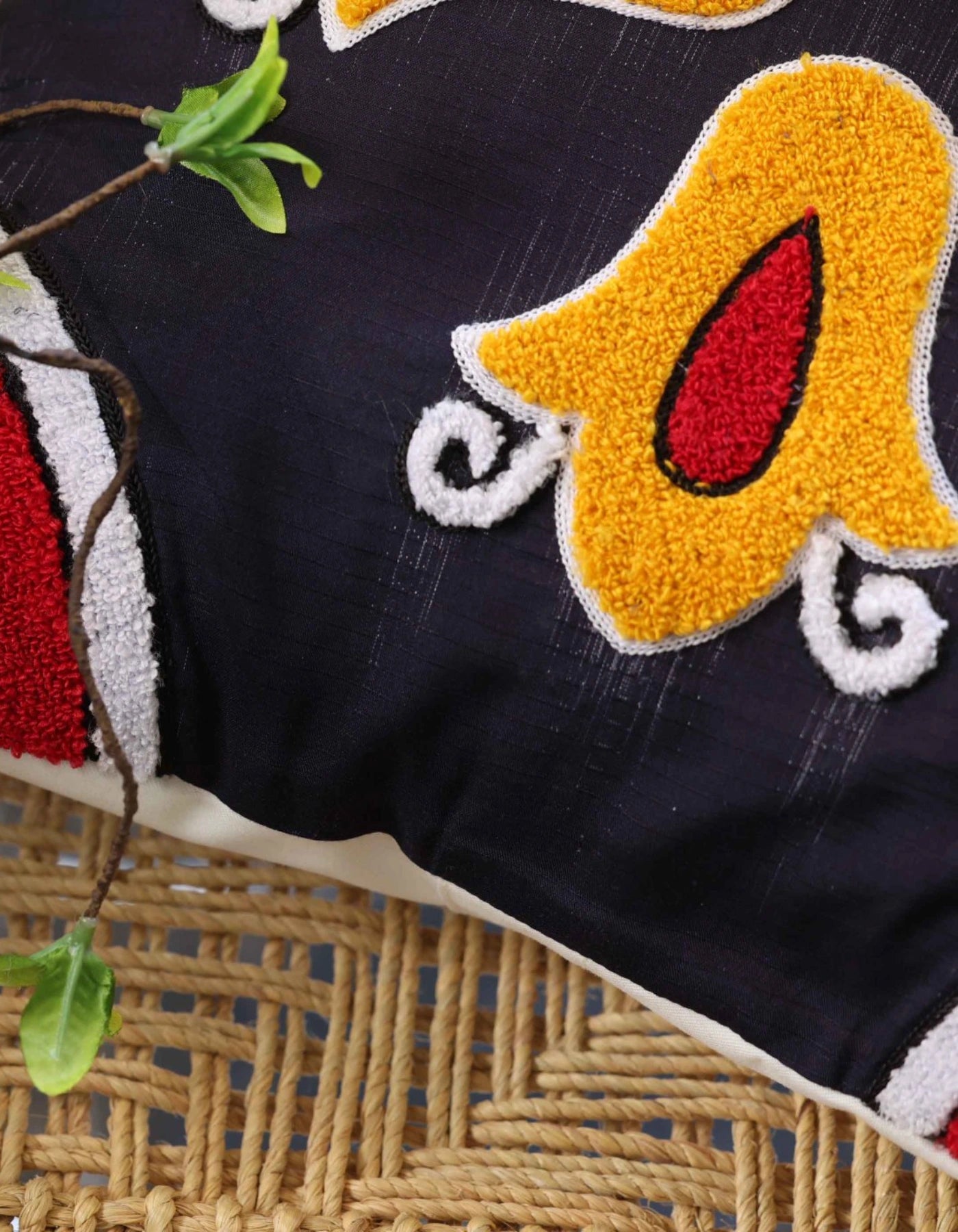 Embroidered fabric with colorful elephant design on a textured surface